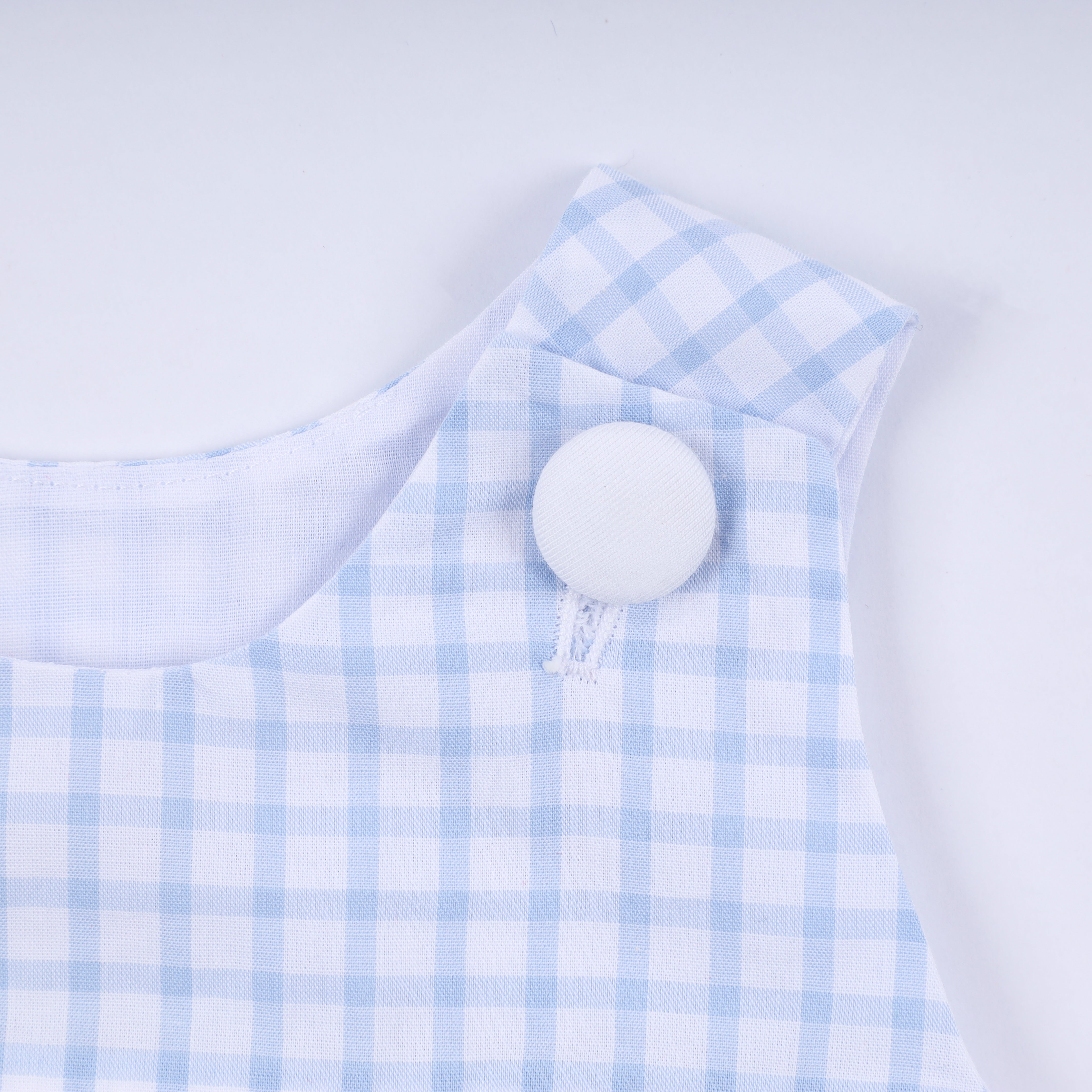 Blue character hand smocked gingham bubble